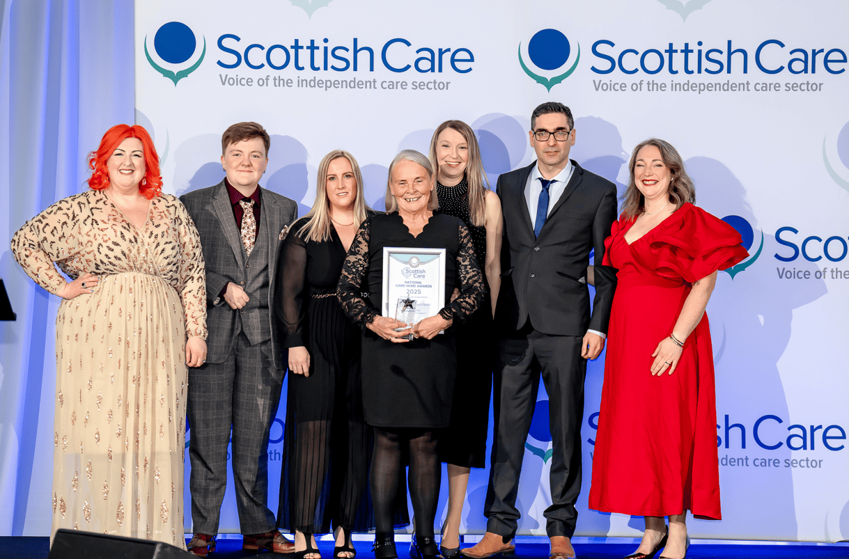 Michelle McManus presents staff from Wyndwell Care Home Peterhead an award for meaningful activity at the Scottish Care awards 2025. 