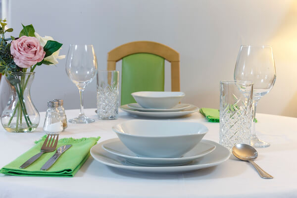 Plates, silverware, and napkins are neatly arranged on the table, ready for diners