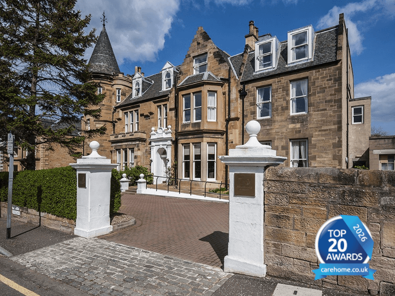 Exterior of Glencairn Care Home - a period building located in Edinburgh. In the bottom right hand corner is an award badge for carehome.co.uks 'top 20 care homes' of 2026. 