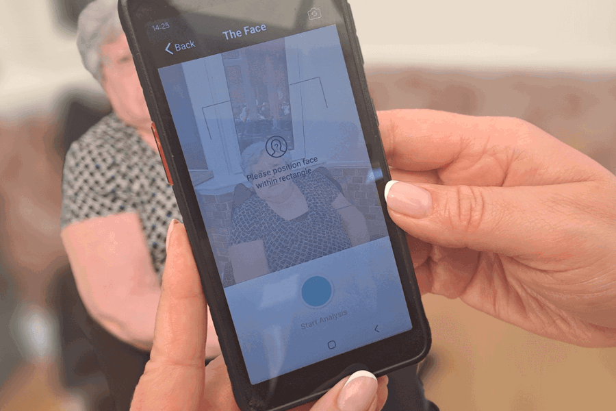 A nourish phone shows a facial analysis on painchek