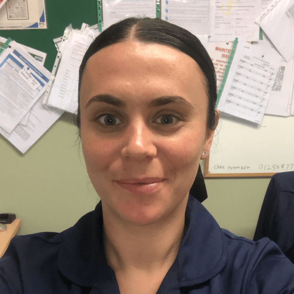A head and shoulders photograph of Natasha Cowan, interim home manager at Beech Manor care home. Natasha has a dark, navy blue blouse on and a ponytail.
