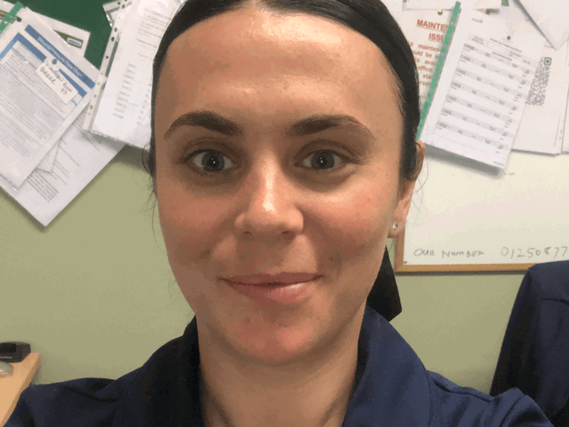 A head and shoulders photograph of Natasha Cowan, interim home manager at Beech Manor care home. Natasha has a dark, navy blue blouse on and a ponytail.