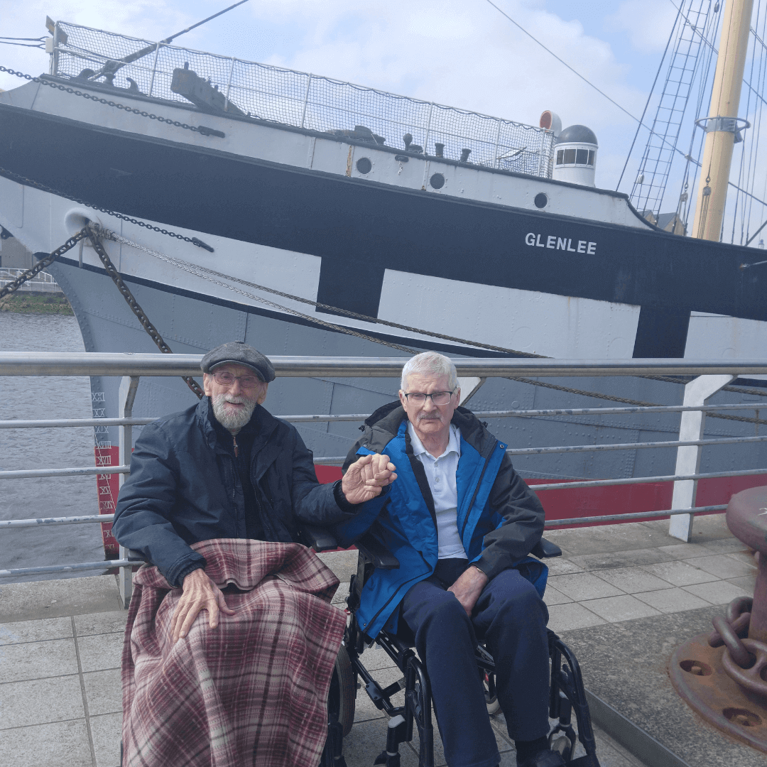 Two care home residents pose infront of the 'Glenlee' ship